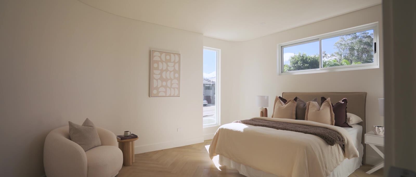 Main bedroom with upholstered bedhead and leafy street outlook